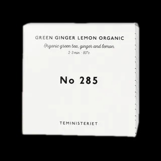 Opakowanie herbaty Teministeriet No 285 Green Ginger Lemon Organic, zawierającej organiczną zieloną herbatę, imbir i cytrynę. Idealna do zaparzania w temperaturze 80°C przez 2–3 minuty. Pudełko w eleganckim, minimalistycznym stylu, białe z czarnymi napisami, charakterystyczne dla marki Teministeriet.