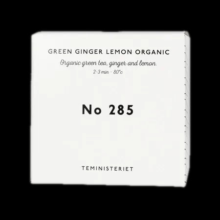 Opakowanie herbaty Teministeriet No 285 Green Ginger Lemon Organic, zawierającej organiczną zieloną herbatę, imbir i cytrynę. Idealna do zaparzania w temperaturze 80°C przez 2–3 minuty. Pudełko w eleganckim, minimalistycznym stylu, białe z czarnymi napisami, charakterystyczne dla marki Teministeriet.