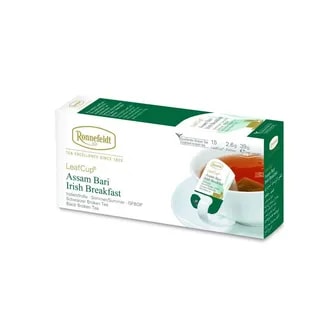 Opakowanie herbaty Ronnefeldt LeafCup Assam Bari Irish Breakfast. Zawiera 15 saszetek herbaty liściastej o smaku Assam Bari Irish Breakfast. Widoczna filiżanka z zaparzoną herbatą i torebką Ronnefeldt. Na opakowaniu znajduje się logo marki, oraz informacje o gramaturze: 2,6g x 15 sztuk (39g netto).