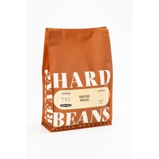 Opakowanie kawy "Rarytas Migdał" od Hard Beans przedstawia elegancką torbę, która zawiera unikalny blend espresso o wyrazistym smaku z nutą migdałową. Idealna dla miłośników kawy poszukujących wyjątkowych doznań aromatycznych i smakowych.
