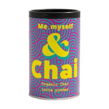 Kolorowe opakowanie Organic Chai Latte Powder marki Me, Myself & Chai. Cylindryczna puszka z intensywnym wzorem różowo-niebieskich fal oraz wyraźnym żółtym napisem 'Me, myself & Chai'. Zawiera organiczny proszek do przygotowania chai latte, idealny dla miłośników tej aromatycznej i korzennej herbaty.