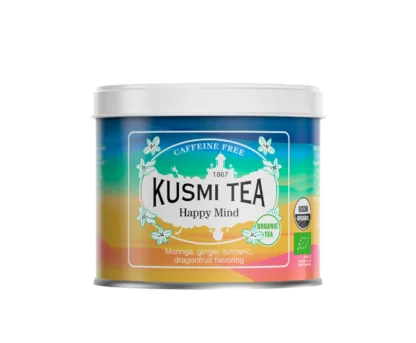 Puszka herbaty Kusmi Tea Happy Mind w energetycznych barwach niebieskiego, żółtego i pomarańczowego, z napisem „Caffeine Free” i informacją o składzie: moringa, imbir, kurkuma, aromat smoczego owocu.