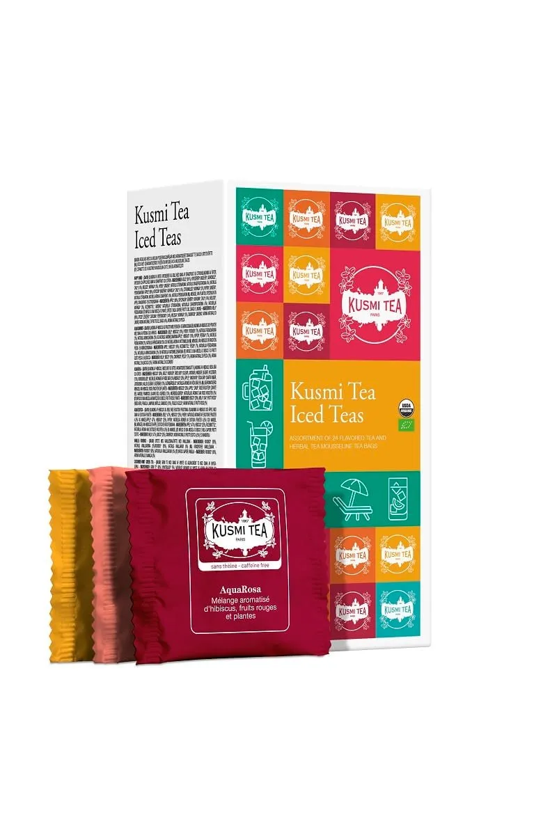 Zestaw herbat Kusmi Tea Ice Teas – 24 kopertki z aromatycznymi mieszankami idealnymi do parzenia na zimno; kolorowe opakowanie z grafikami letnimi i saszetkami AquaRosa na pierwszym planie.