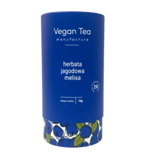 Granatowe, cylindryczne opakowanie herbaty Vegan Tea z ilustracją jagód przy podstawie. Na froncie biały napis: „herbata jagodowa melisa, masa netto 70g, 20 filiżanek naparu”. Naturalna mieszanka z nutą owocową i uspokajającą melisą.