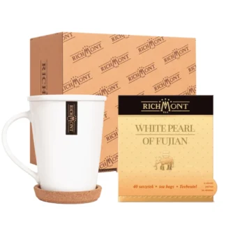 Na zdjęciu widoczny jest zestaw składający się z eleganckiego kubka oraz opakowania białej herbaty Richmont – Pearl of Fujian. W zestawie znajduje się 40 torebek herbaty, idealnej na relaksujące chwile przy aromatycznym naparze.