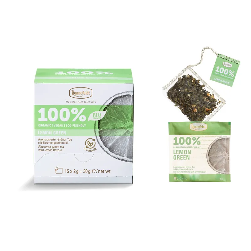 Opakowanie ekologicznej zielonej herbaty cytrynowej 100% marki Ronnefeldt z 15 saszetkami, oferującej orzeźwiający smak cytrusów. Idealna dla miłośników herbaty, dbających o środowisko, z opcją łatwego parzenia i pełnym aromatem.