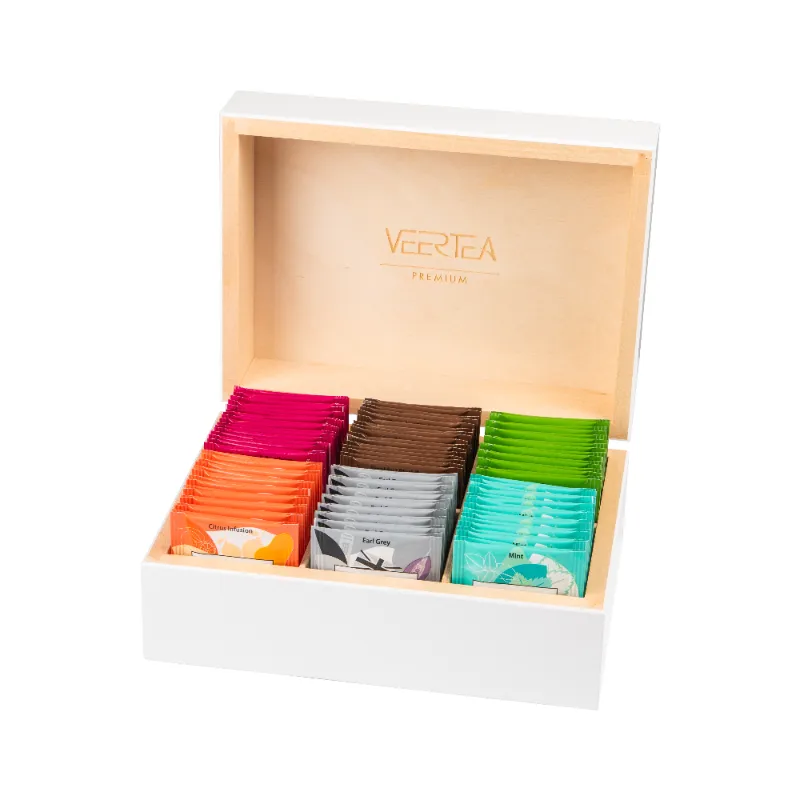 Drewniane pudełko z zestawem różnorodnych herbat VEERTEA, idealne dla miłośników aromatycznych naparów. W komplecie znajdują się kolorowe torebki herbaty, które oferują bogaty wachlarz smaków, doskonałe na każdą okazję.